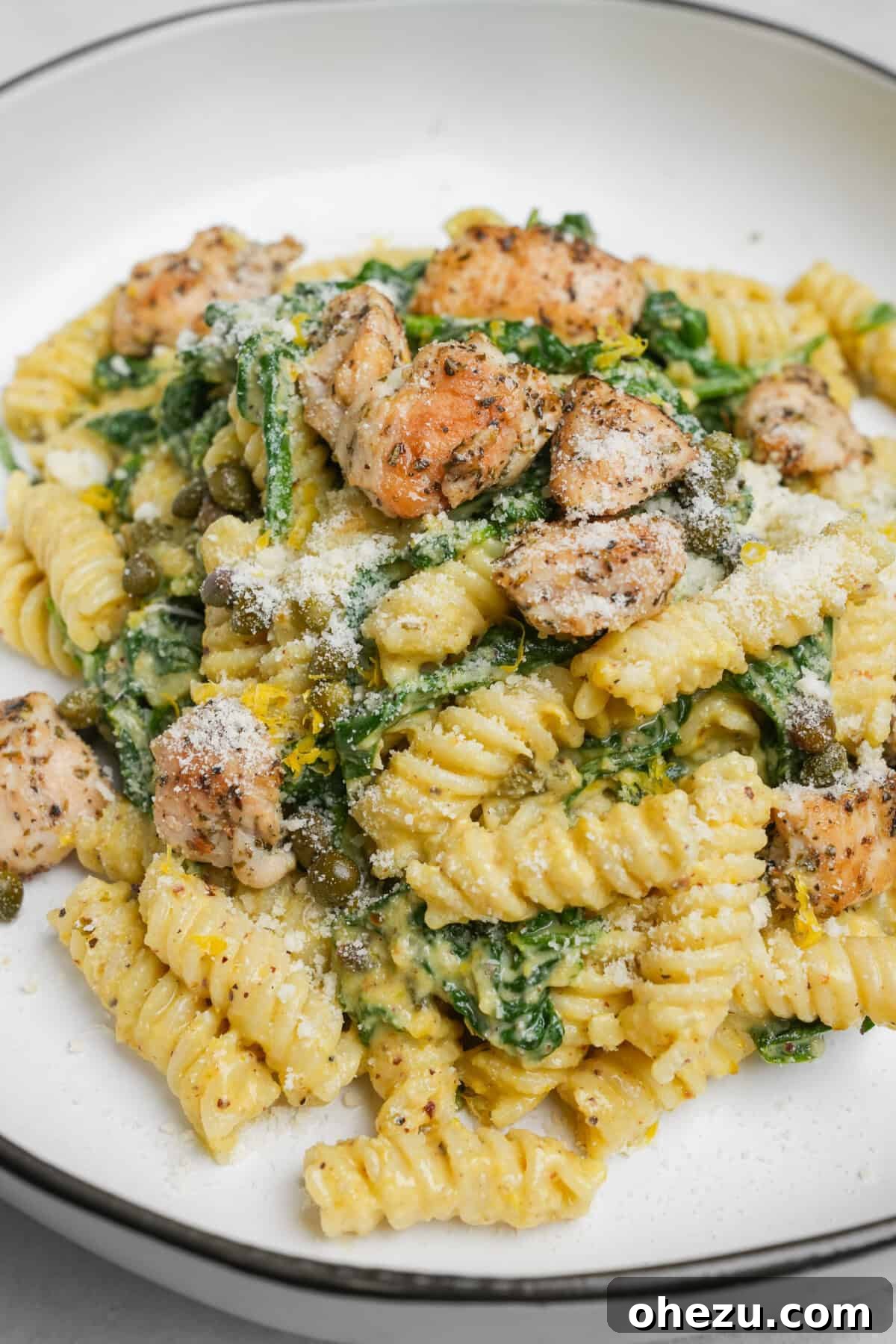 chicken and spinach pasta on a plate