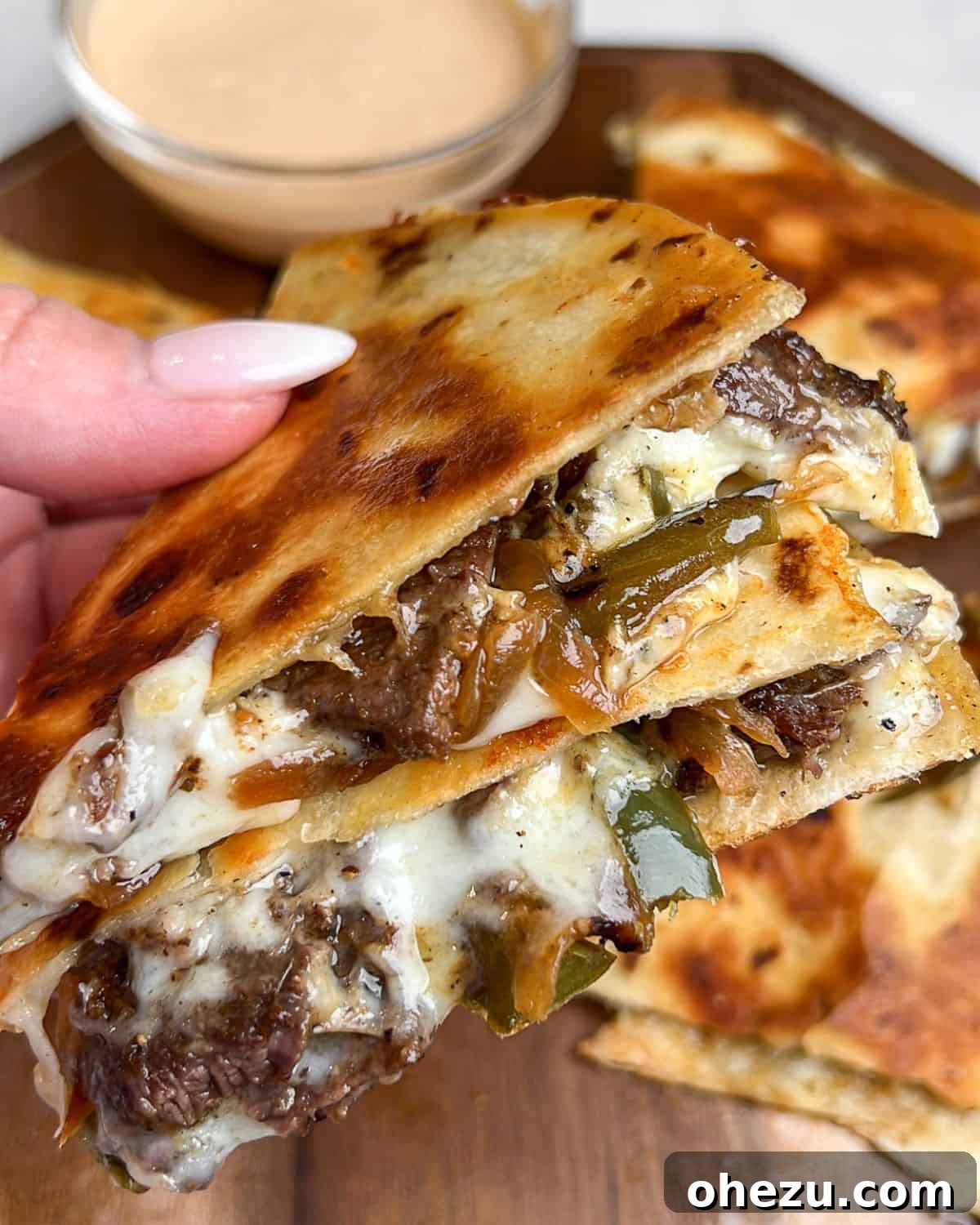 Smoky Steak Quesadillas with Creamy Chipotle Drizzle 3 A close-up side view of perfectly cooked steak quesadillas, showcasing the generous melted cheese and steak filling.