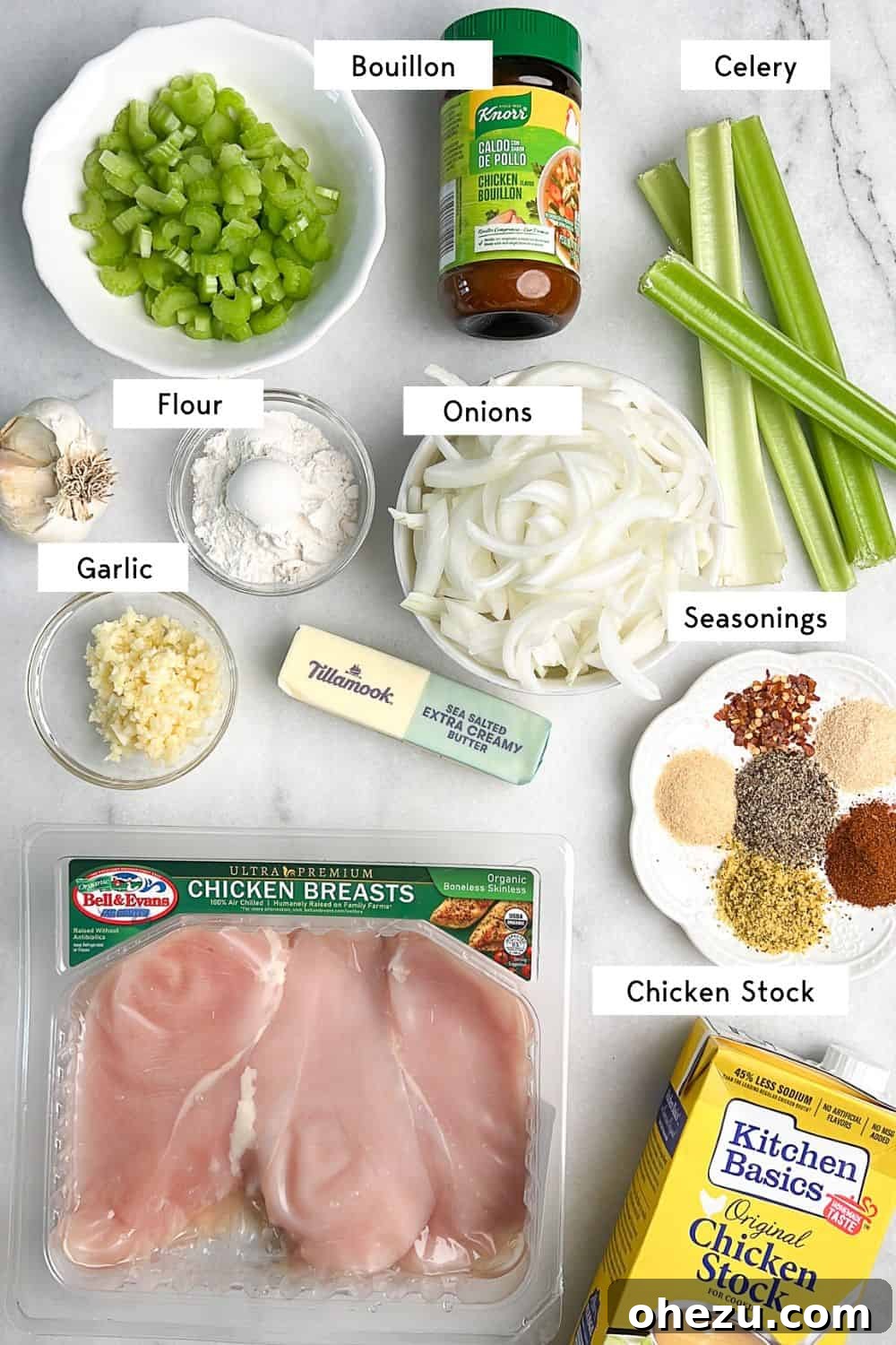 This slow cooker smothered chicken, with its creamy gravy and melt-in-your-mouth texture, is the ultimate cozy meal. And it's so easy! Labeled key ingredients for the slow cooker smothered chicken recipe displayed on a rustic wooden board.