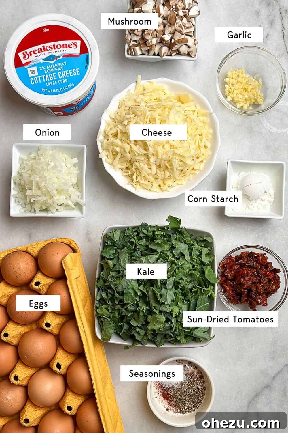 See all the fresh ingredients you'll need to create these delicious, fluffy, and protein-packed kale and mushroom egg bites. Clearly labeled ingredients laid out for making the kale and mushroom egg bites recipe.