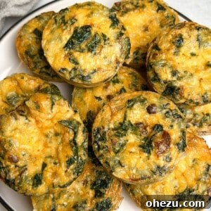 Kale and mushroom egg bites piled on a plate.