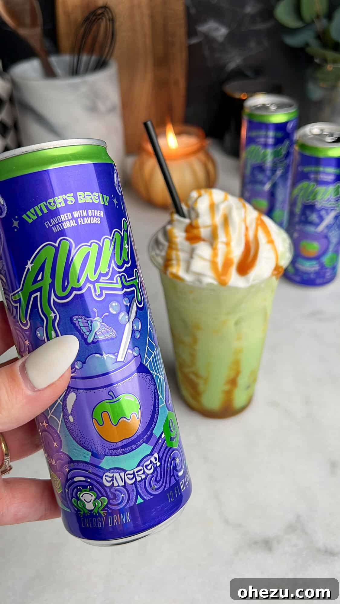 a can of alani witches brew in front of a finished homemade caramel apple drink