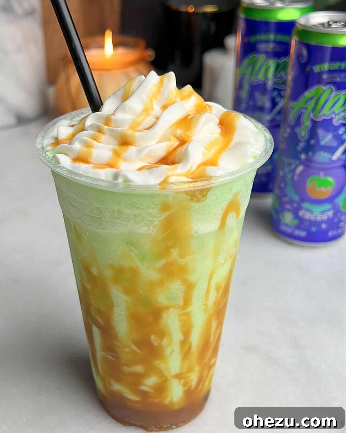 green apple drink with caramel sauce drizzled on the side and whipped cream on top, a finished homemade Alani Witches Brew