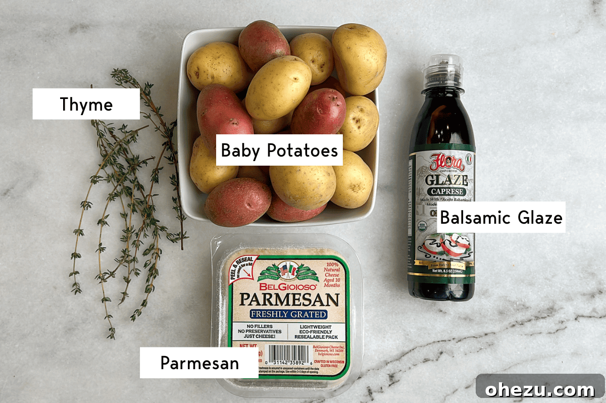 All key ingredients for Parmesan roasted potatoes laid out: baby potatoes, grated Parmesan, fresh thyme, butter, olive oil, pepper, flaky sea salt, and balsamic glaze.