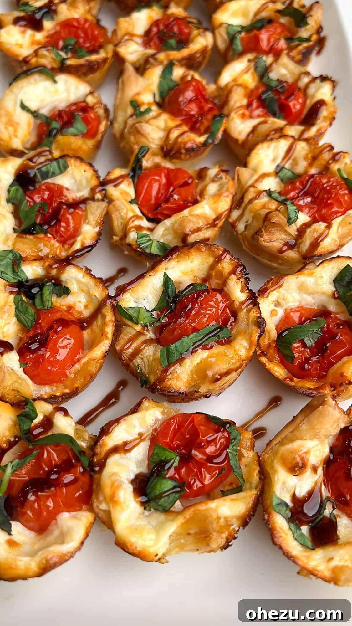Overhead view of puff pastry caprese bites on the countertop, ready to be served, showcasing their golden crust and vibrant colors