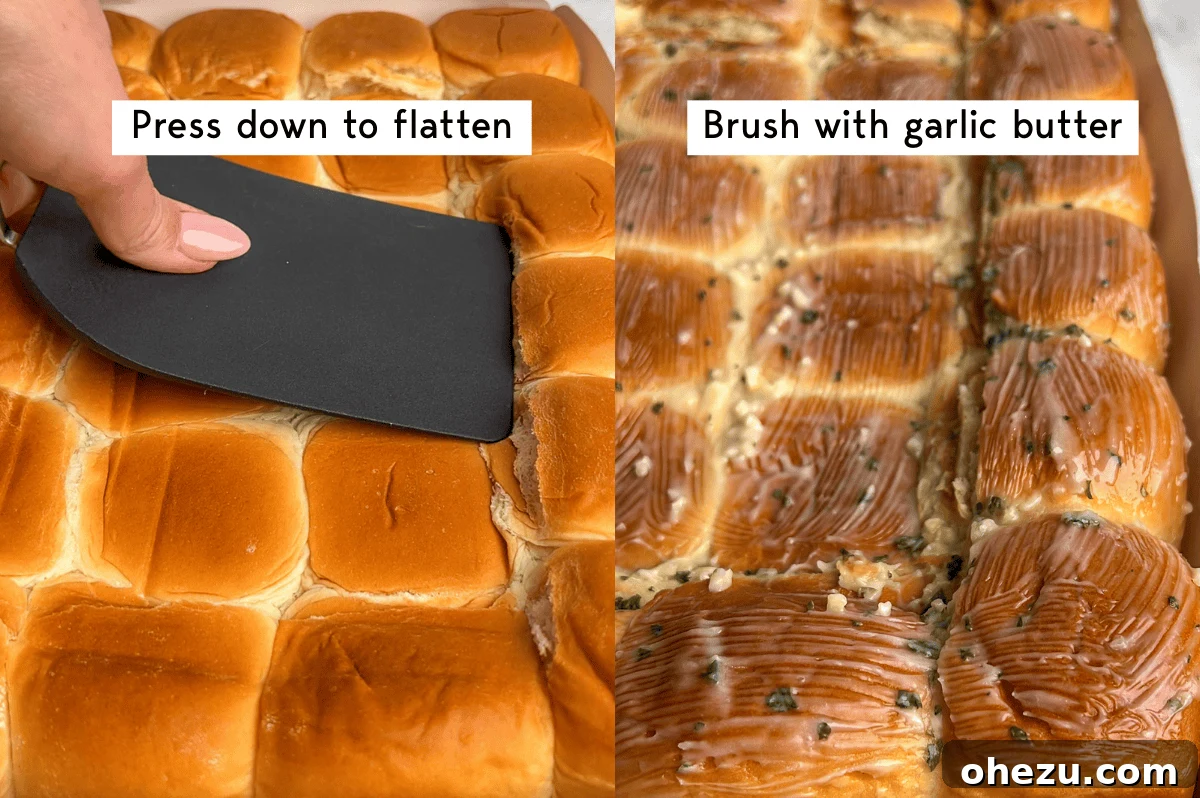 A close-up image showing Hawaiian rolls being pressed down with a spatula to form the pizza crust.