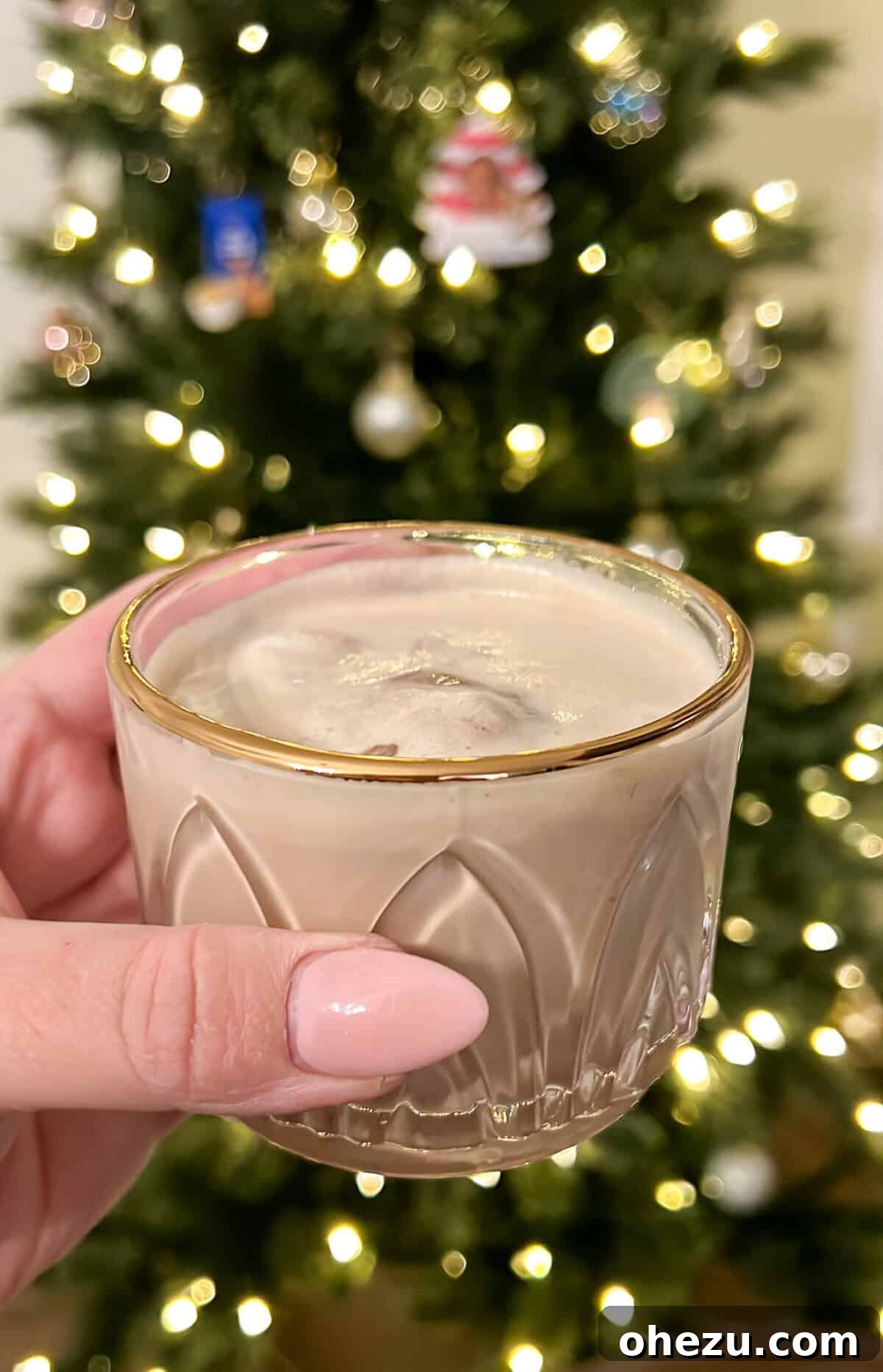 Velvet Coffee Blend 4 A glass with a gold rim holding a cup full of coffee punch, festive for a Christmas tree backdrop.