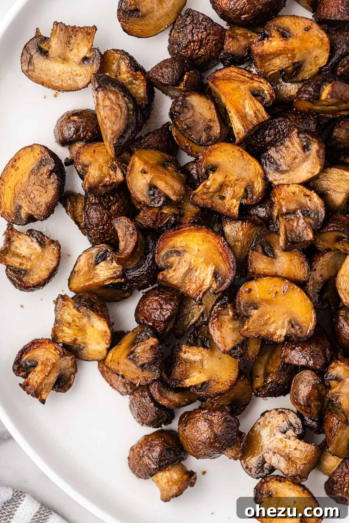 air fryer mushrooms elegantly arranged on a white plate