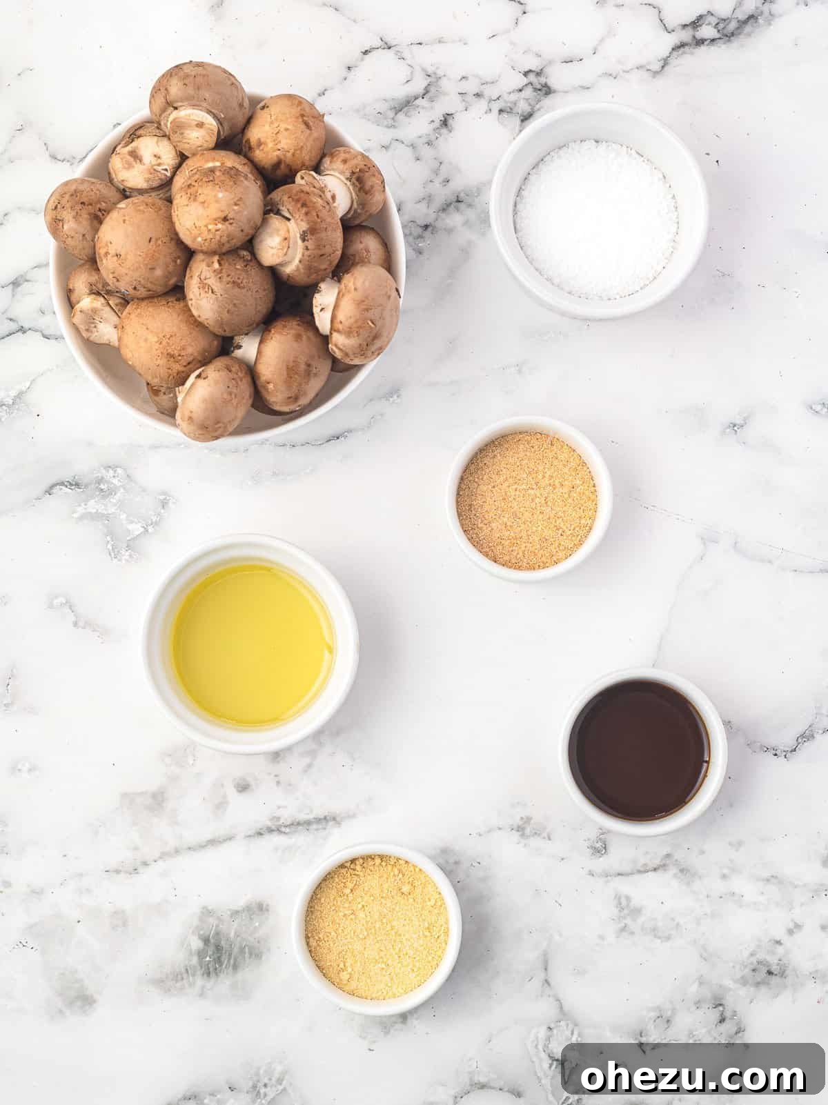 ingredients needed to make air fryer mushrooms on a white surface