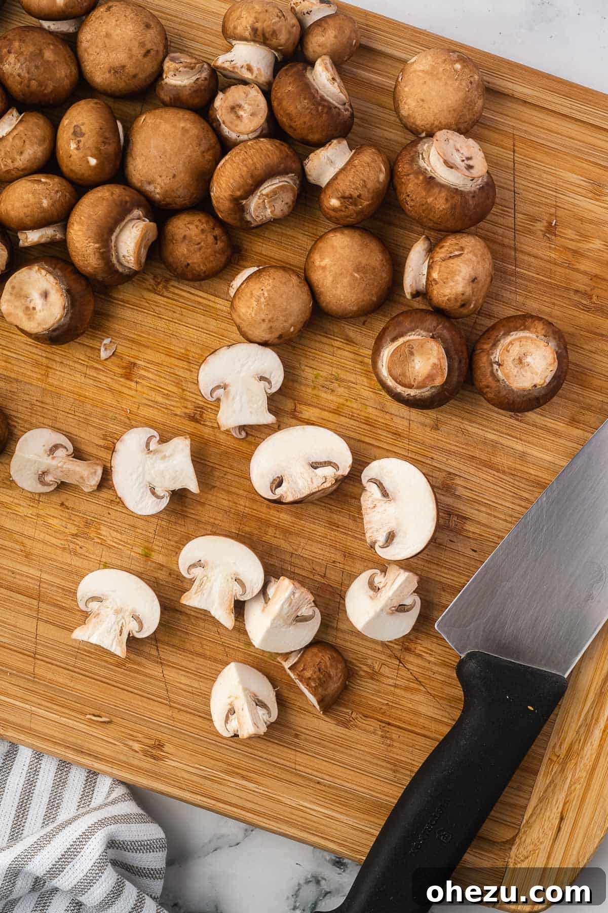 cutting the mushrooms on a wooden cutting board