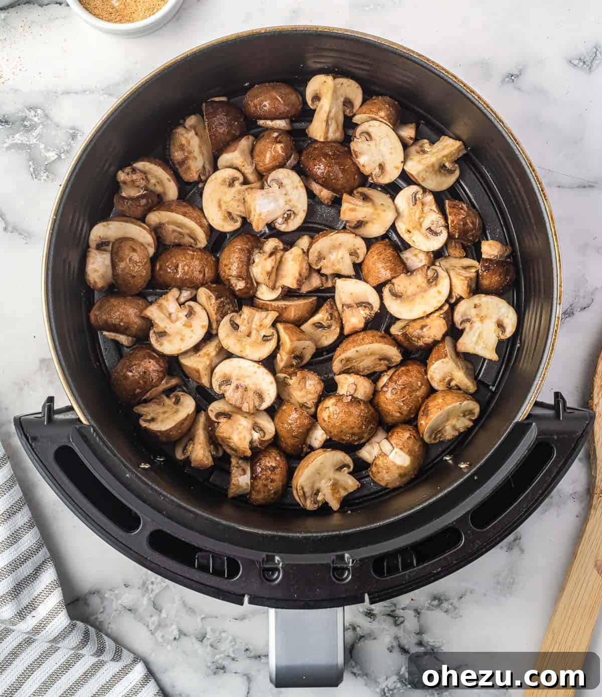 mushrooms cooking in the air fryer basket