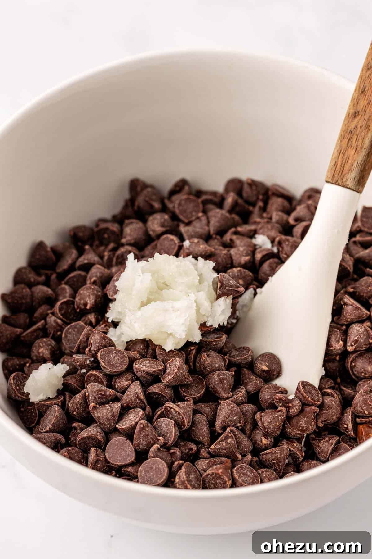 Coconut oil and chocolate chips in a bowl, ready for melting