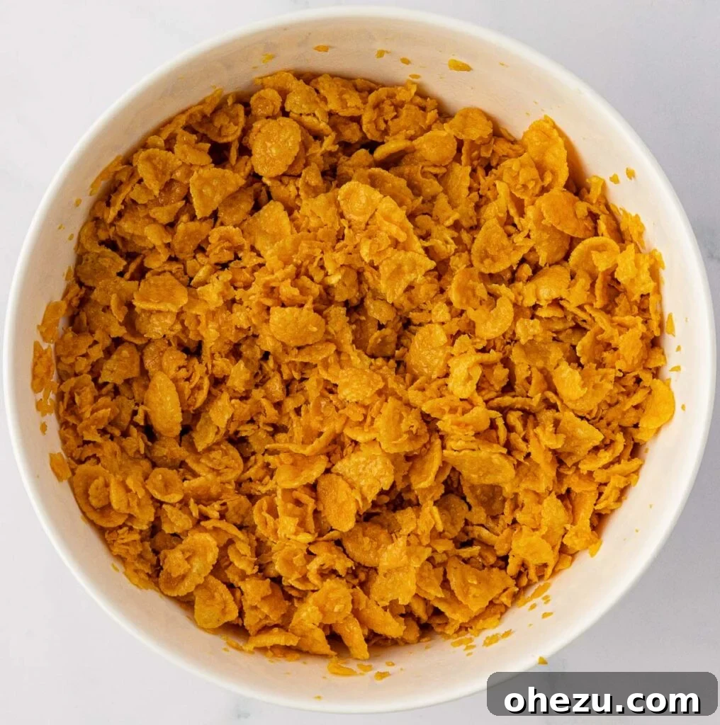 Buttery corn flake topping in a mixing bowl, ready to be spread