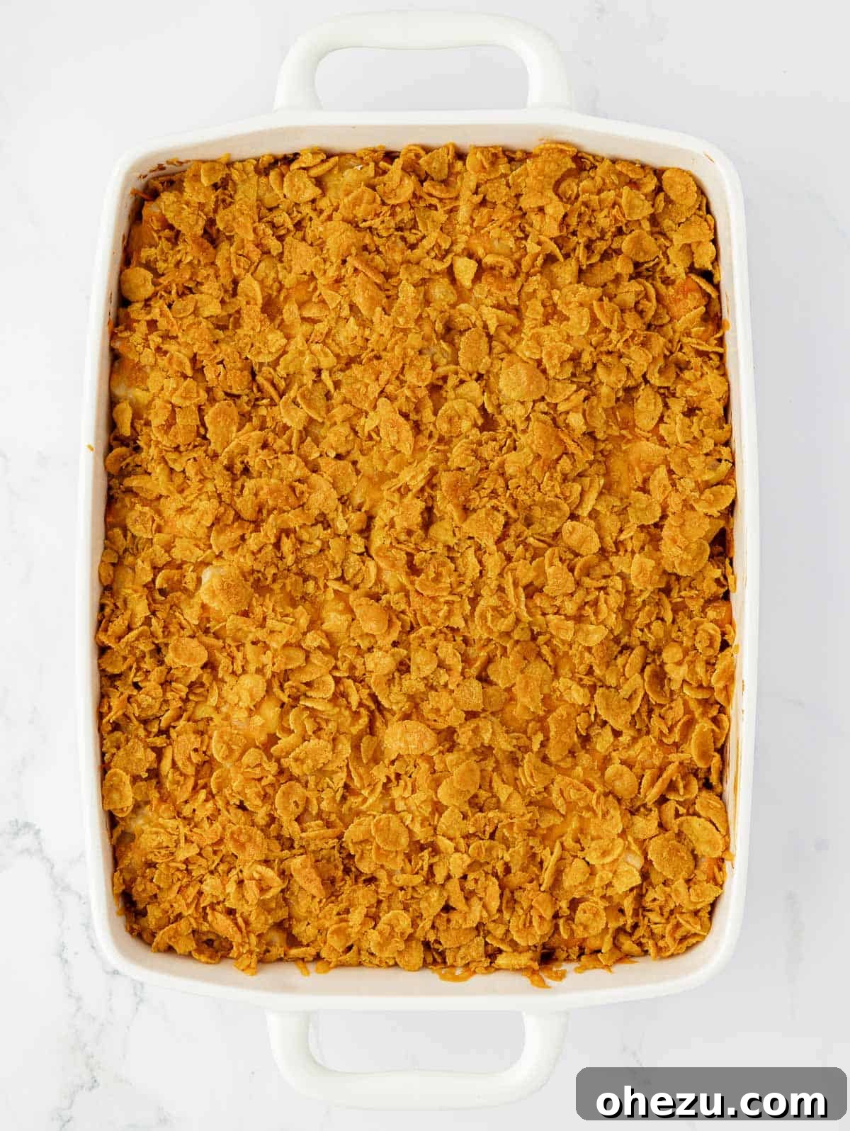 Freshly baked cheesy potatoes with a perfectly browned corn flake topping