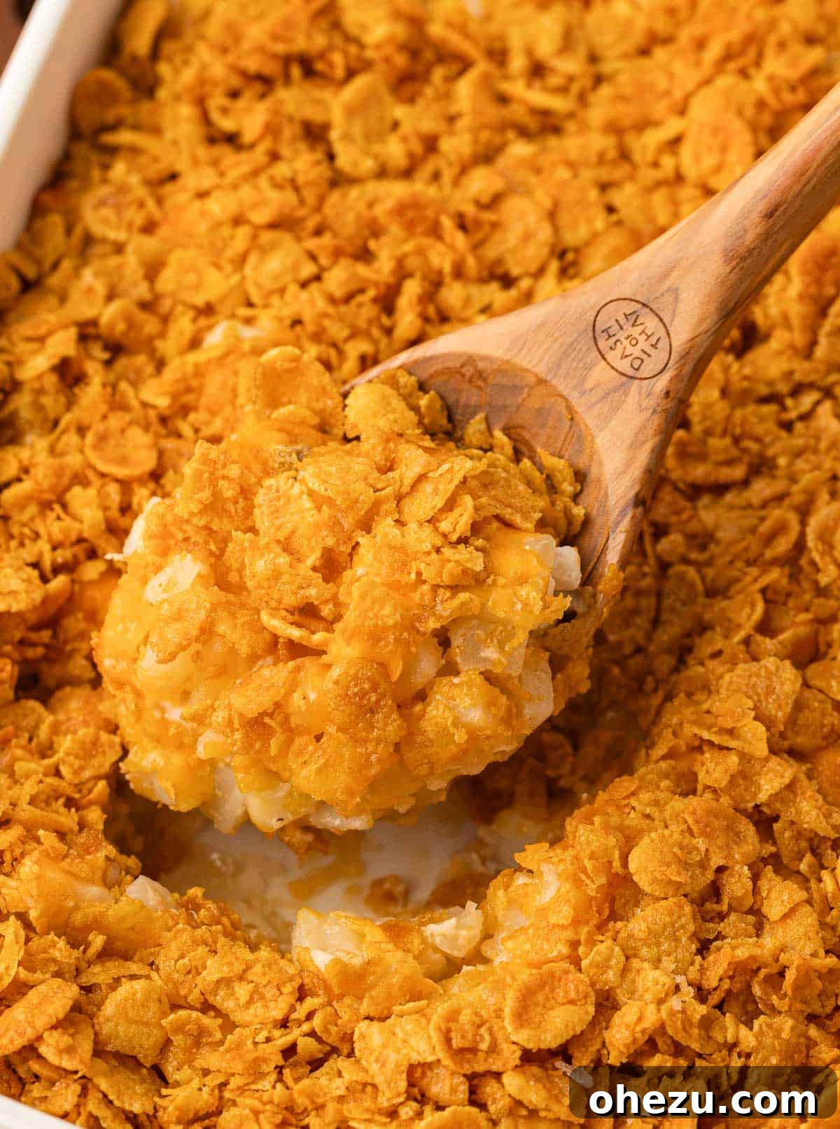 Close-up of a generous scoop of funeral potatoes, showing the creamy interior and crispy topping