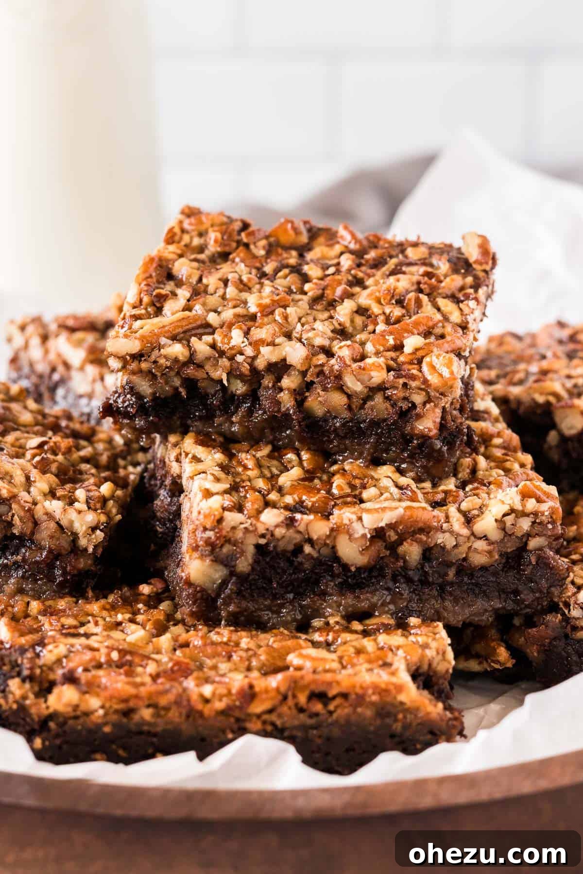 pecan pie brownies cut into squares and stacked on a plate