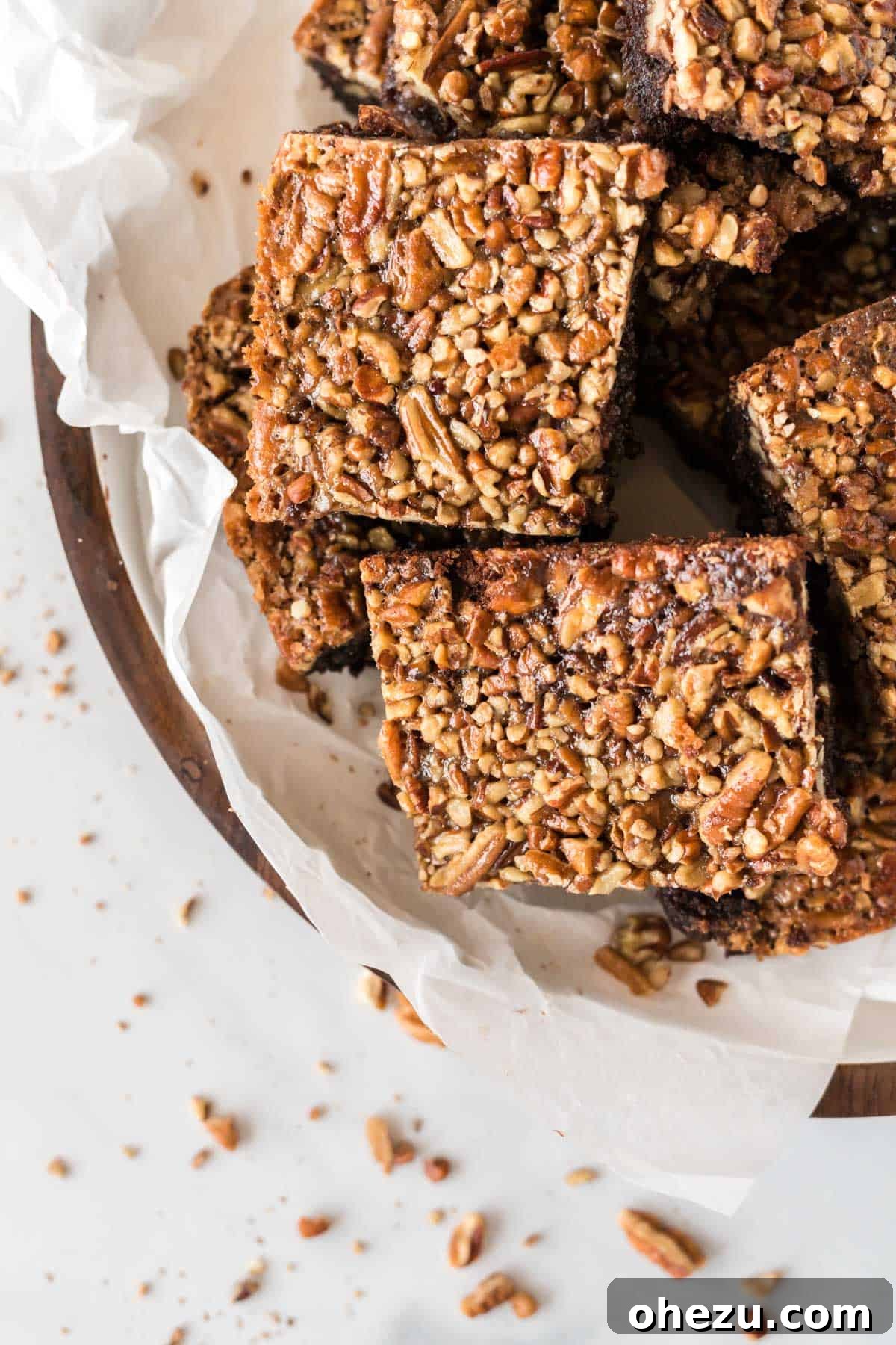 pecan pie brownies cut into squares and stacked on a plate