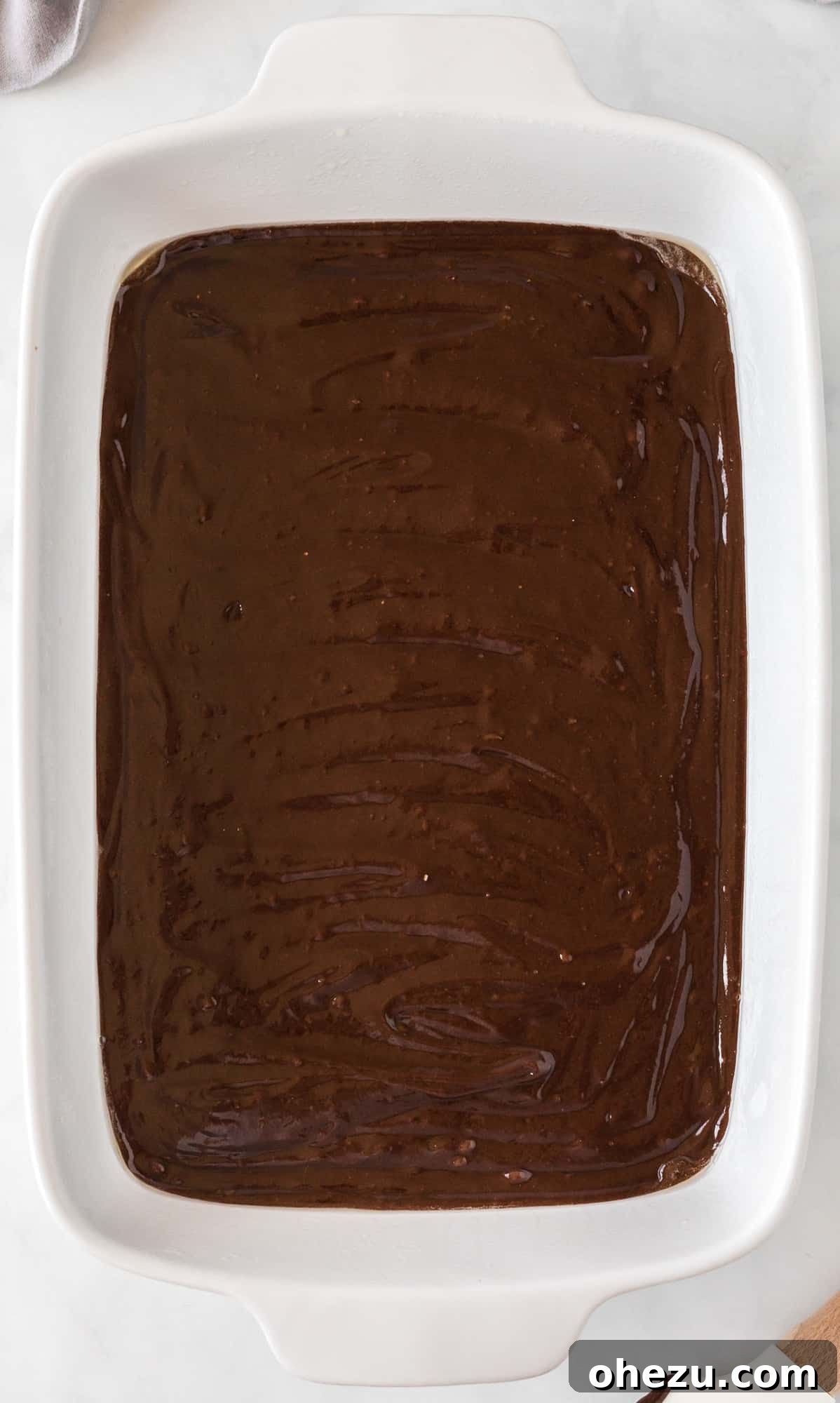 brownie mix spread out in a 9 by 13 baking dish