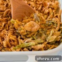 Holiday Green Bean Bake 11 taking a scoop of green bean casserole from the dish