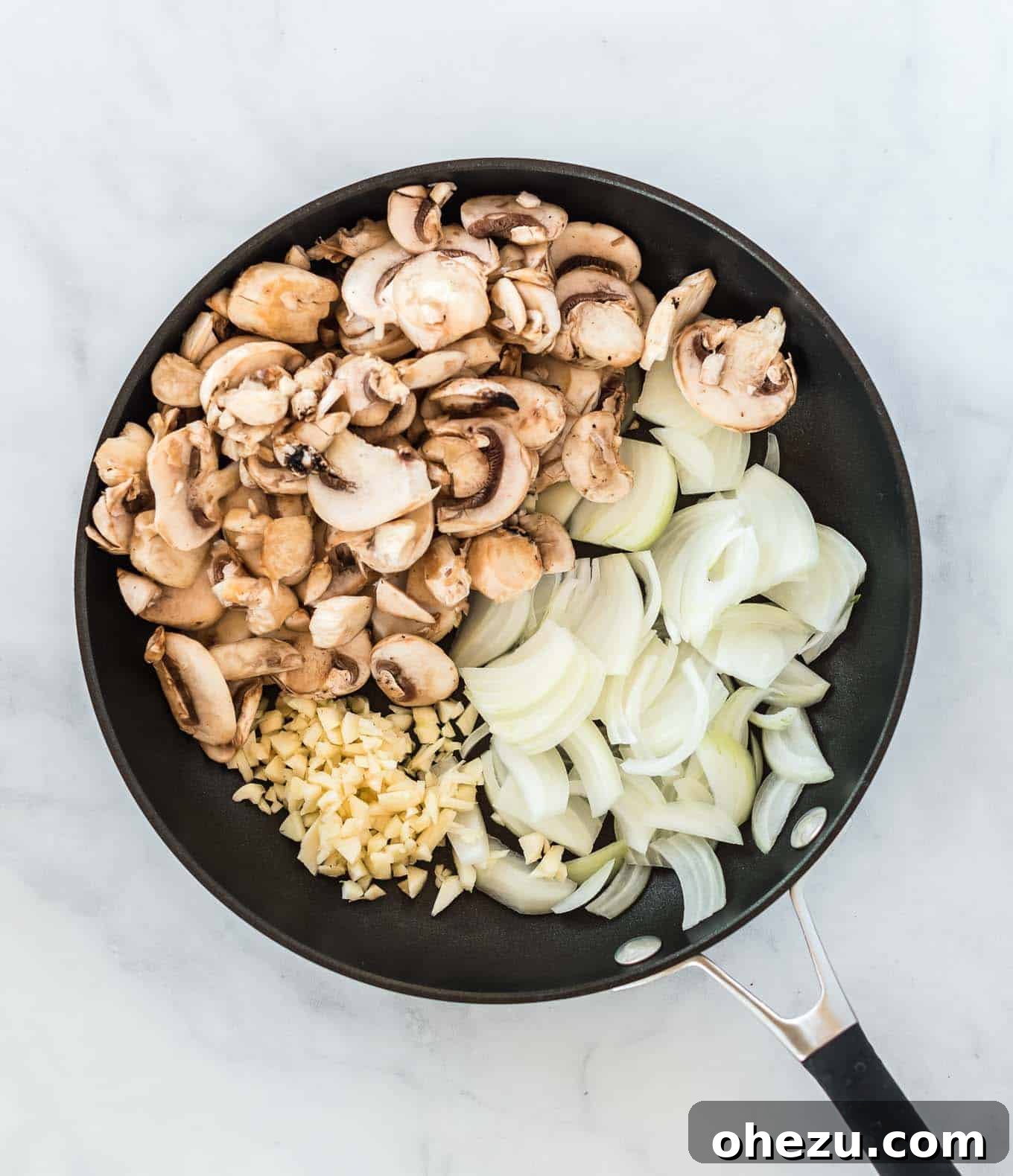 Holiday Green Bean Bake 5 a skillet with mushrooms, minced garlic, and chopped onion in it