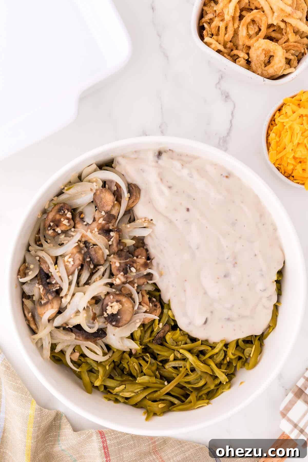 Holiday Green Bean Bake 6 mixing together cream of mushroom soup, mushrooms, and green beans