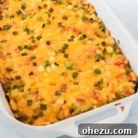 Finished baked hash brown egg casserole in a white dish, a close-up.
