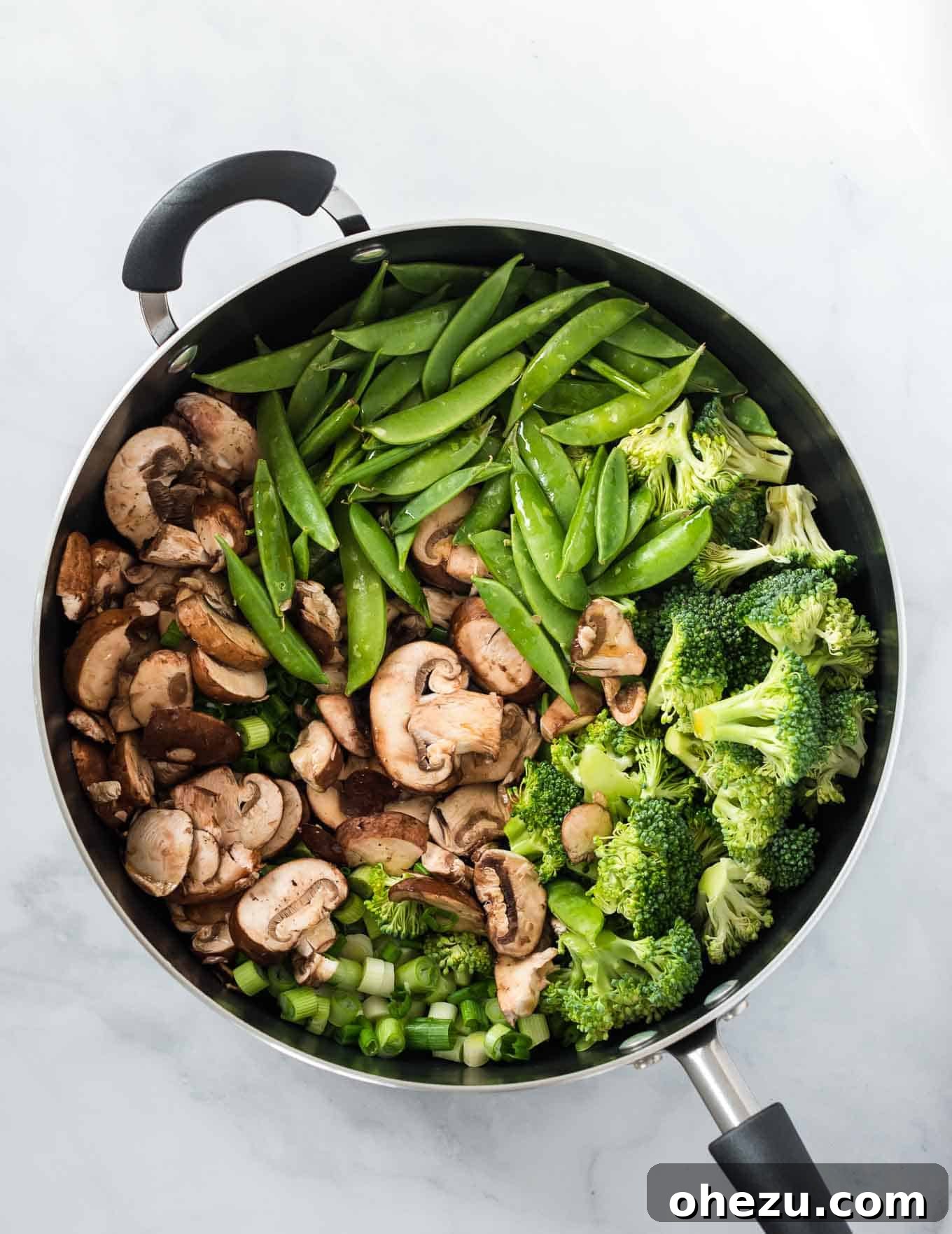 Sweet and Savory Teriyaki Noodles 3 Freshly chopped broccoli, sugar snap peas, sliced mushrooms, and green onions sautéing in a large skillet for teriyaki ramen.
