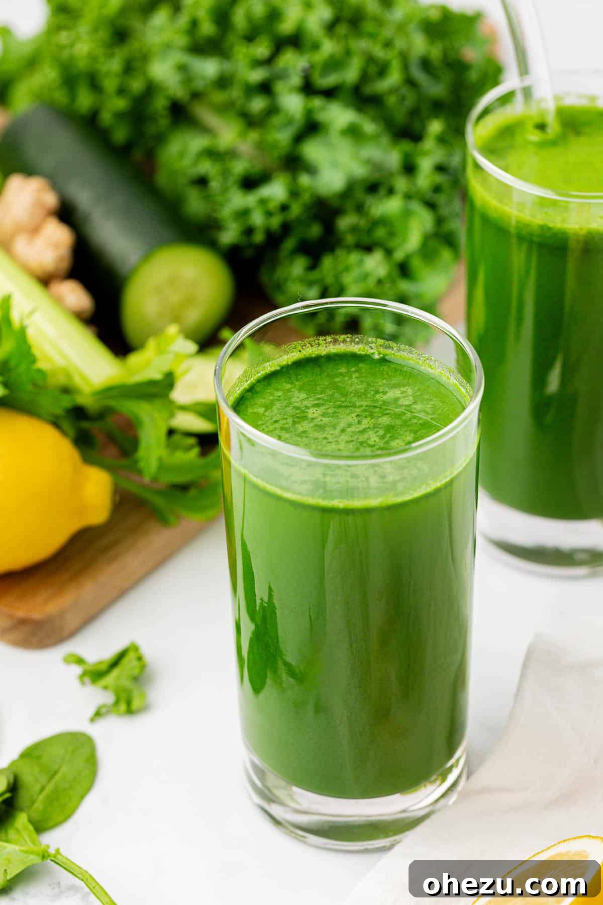 Vibrant Green Goodness 13 A glass of green juice adorned with a fresh lemon slice and a sprig of mint, ready to be served.