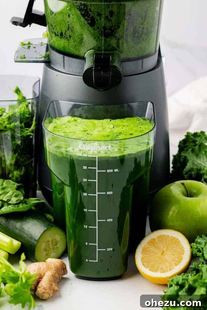 Vibrant Green Goodness 6 A jug of freshly made green juice positioned beside a juicer, with a glass ready for serving.