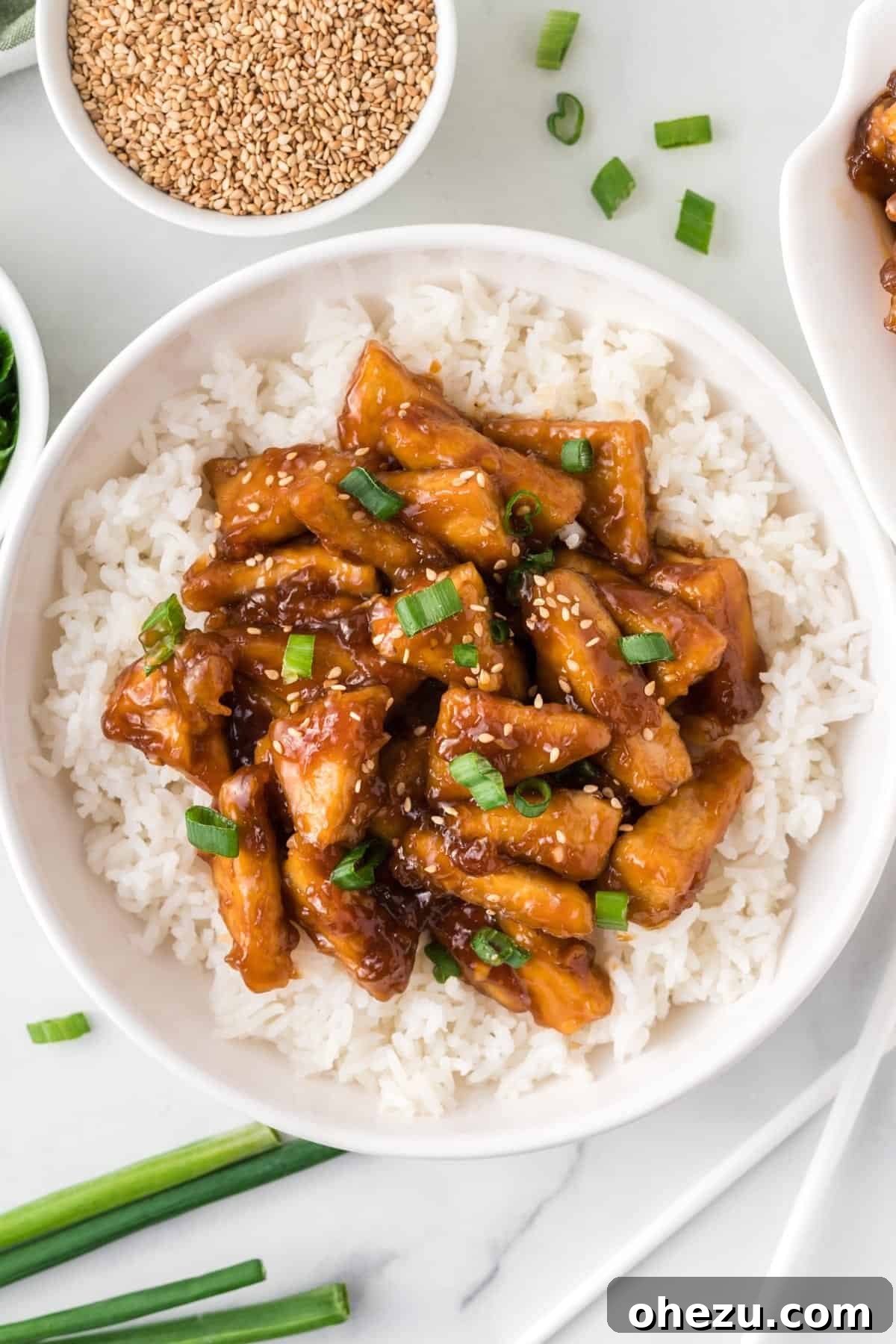 teriyaki tofu triangles over white rice in a bowl