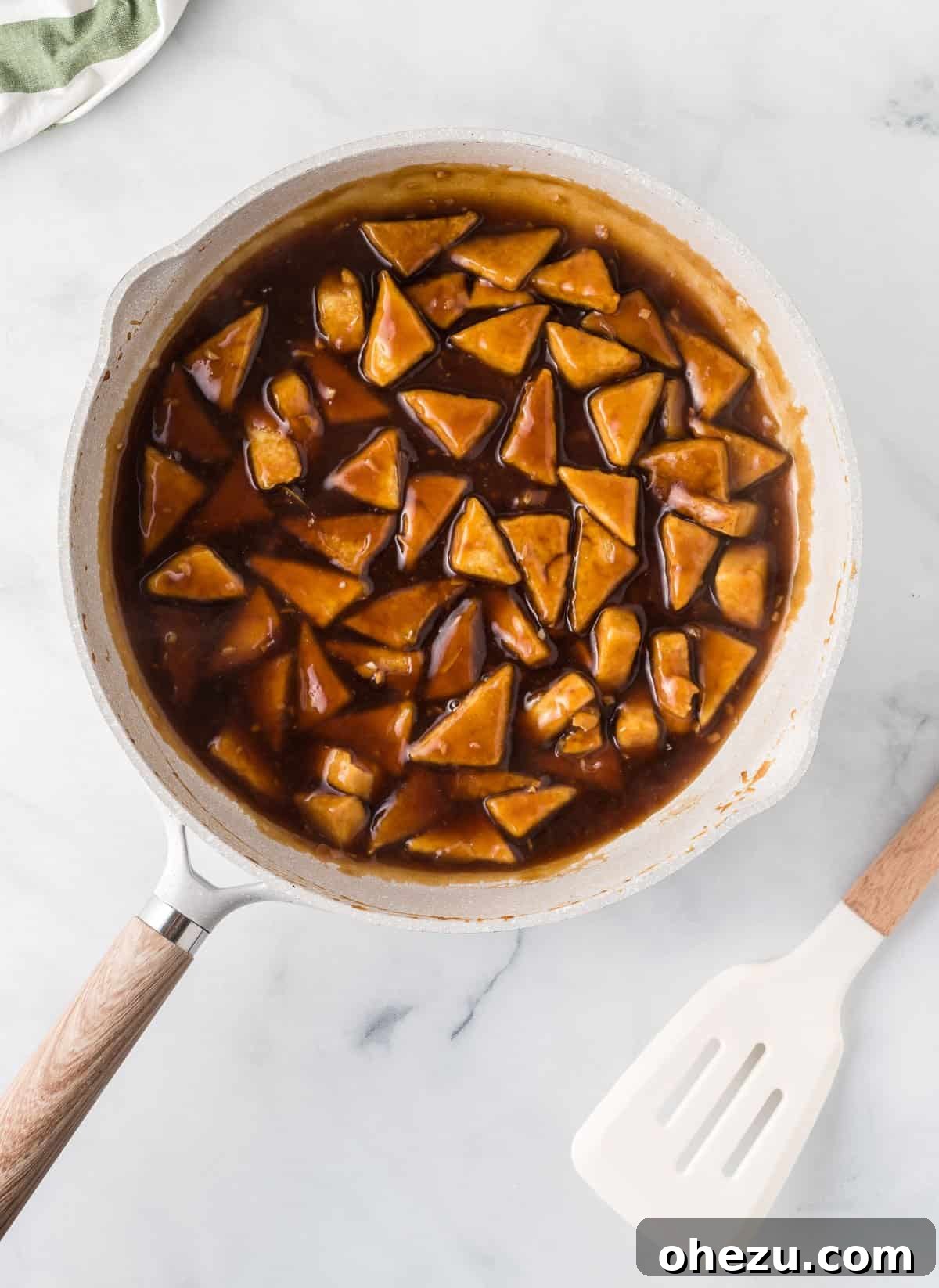 adding the teriyaki sauce to the tofu