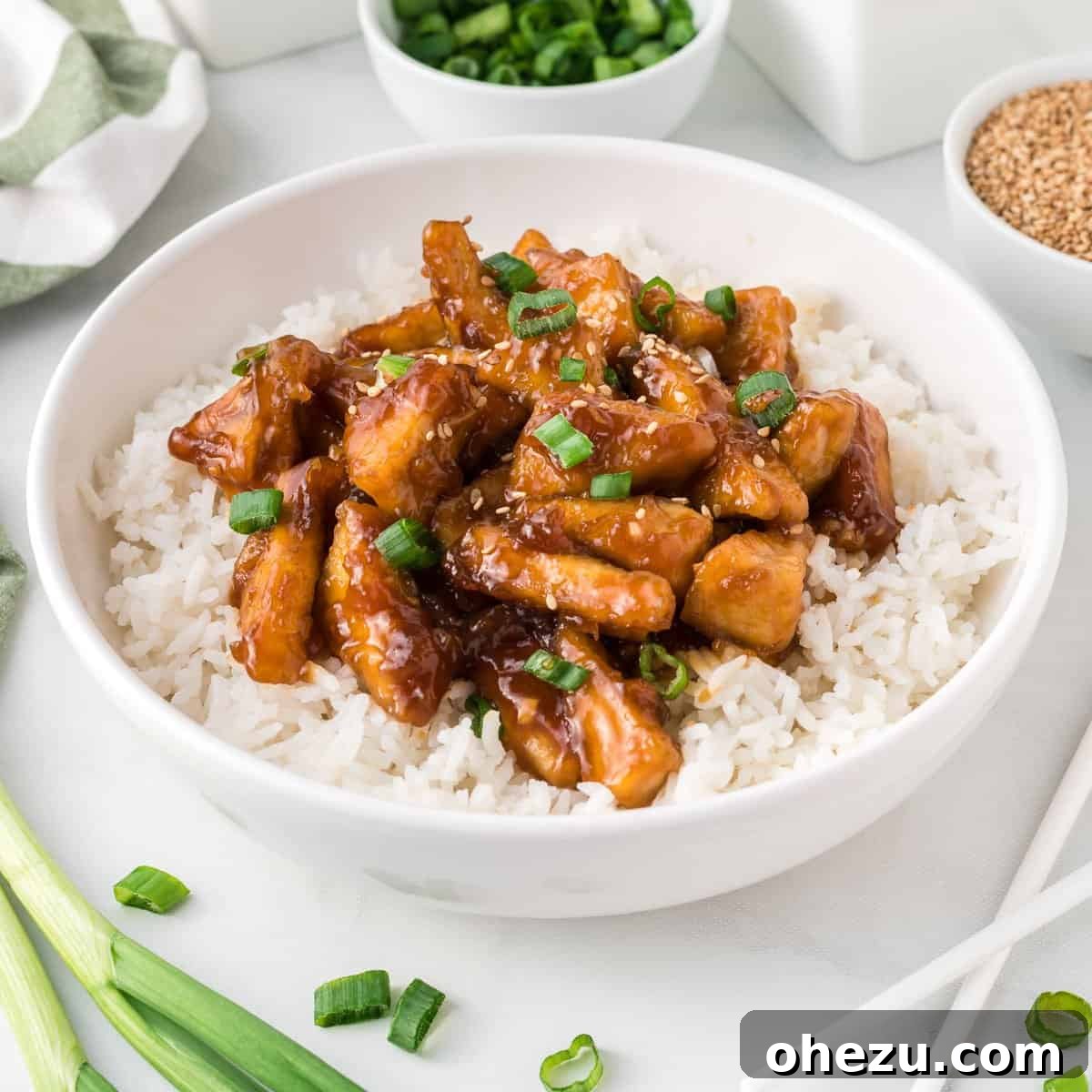 teriyaki tofu triangles over white rice in a bowl