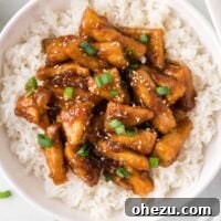 teriyaki tofu triangles over white rice in a bowl