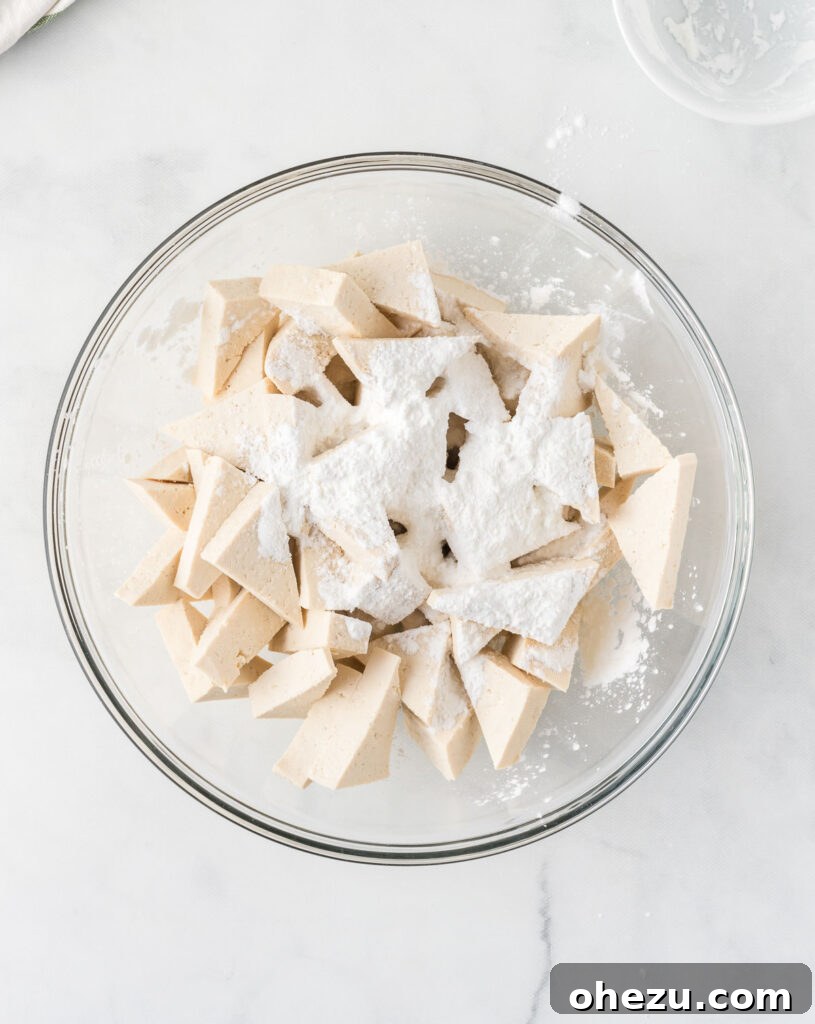 adding corn starch to the tofu