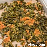 Roasted green beans with parmesan on a baking sheet