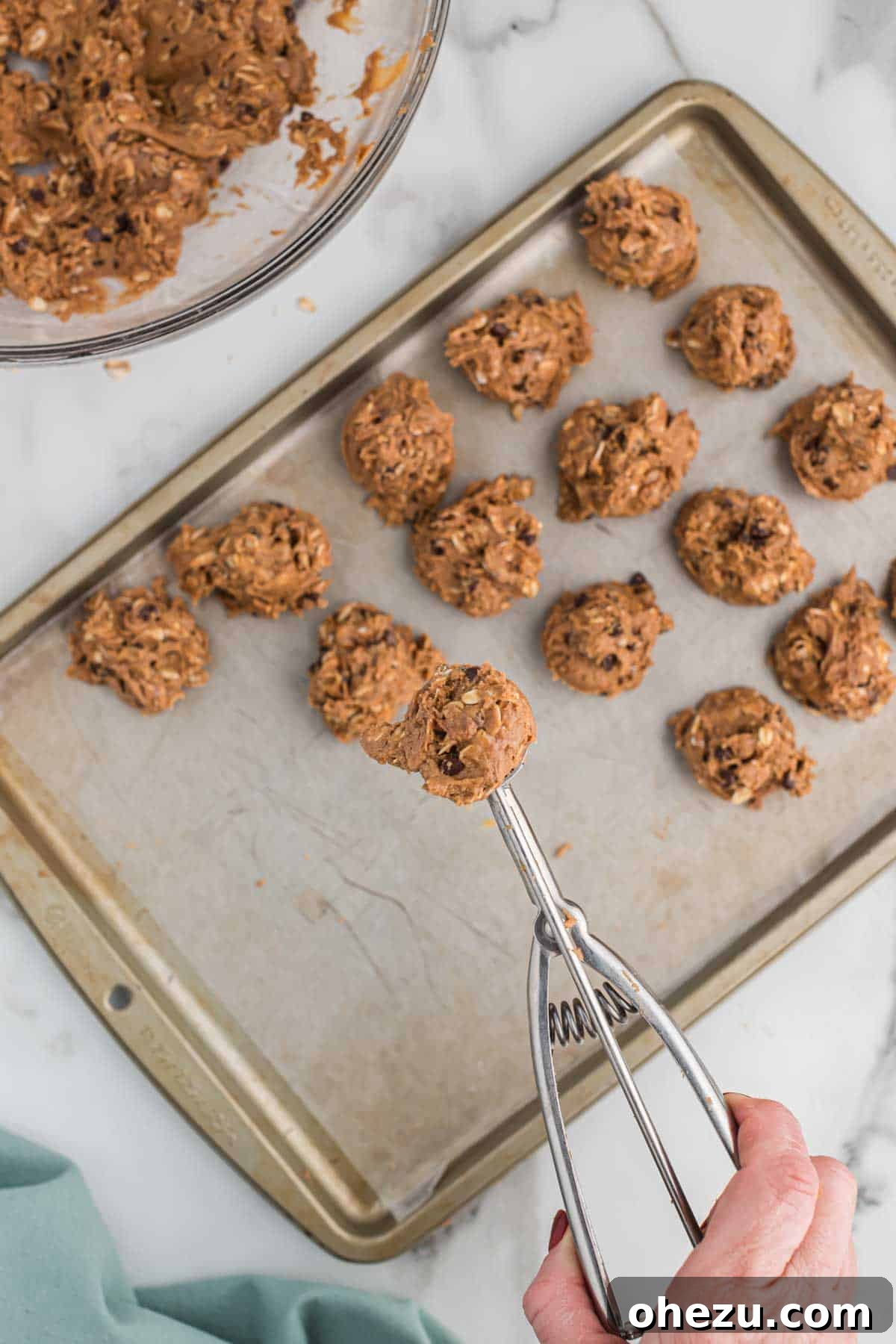 using a mini cookie scoop to form the protein balls