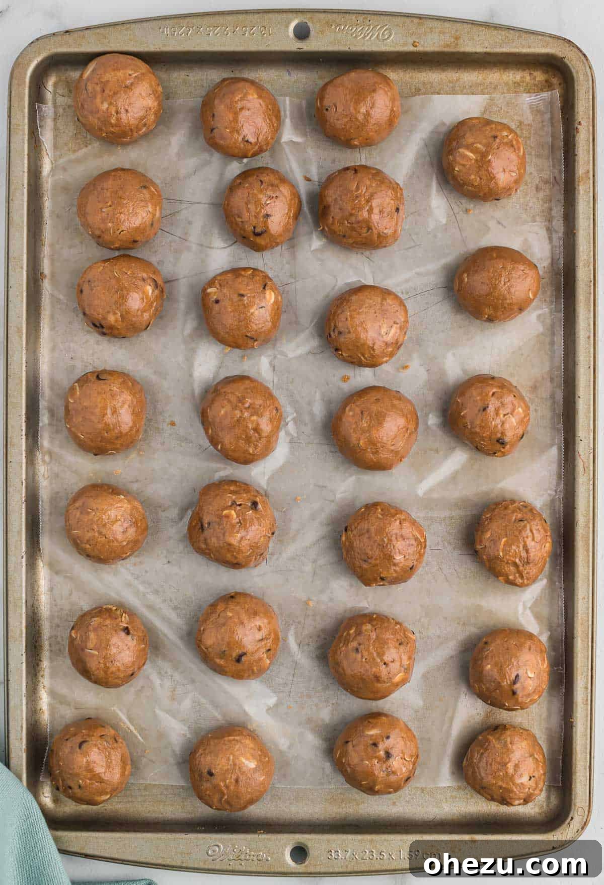 chocolate protein balls on a wax paper lined baking sheet