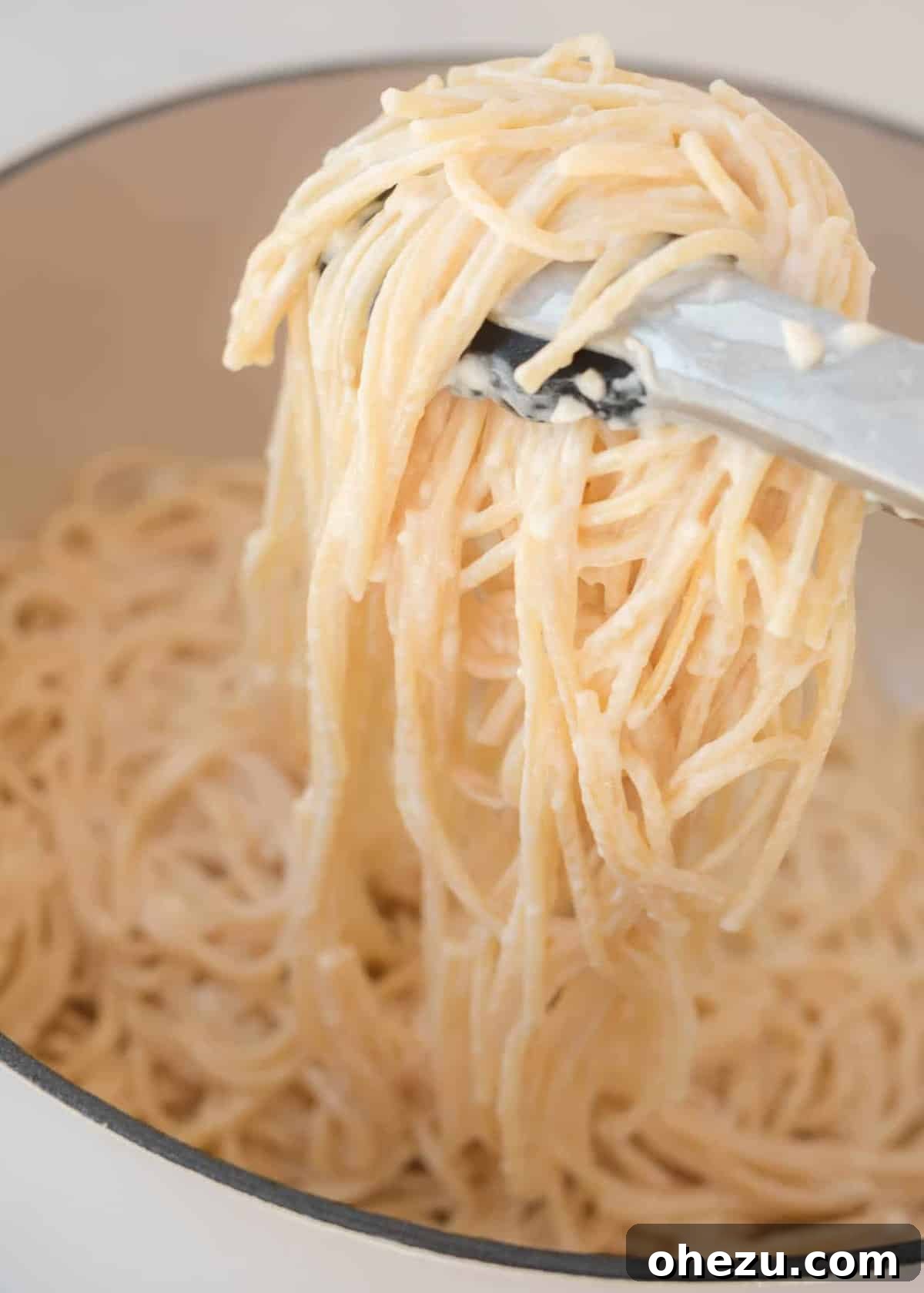 Delicious cream cheese spaghetti noodles being served from a pan