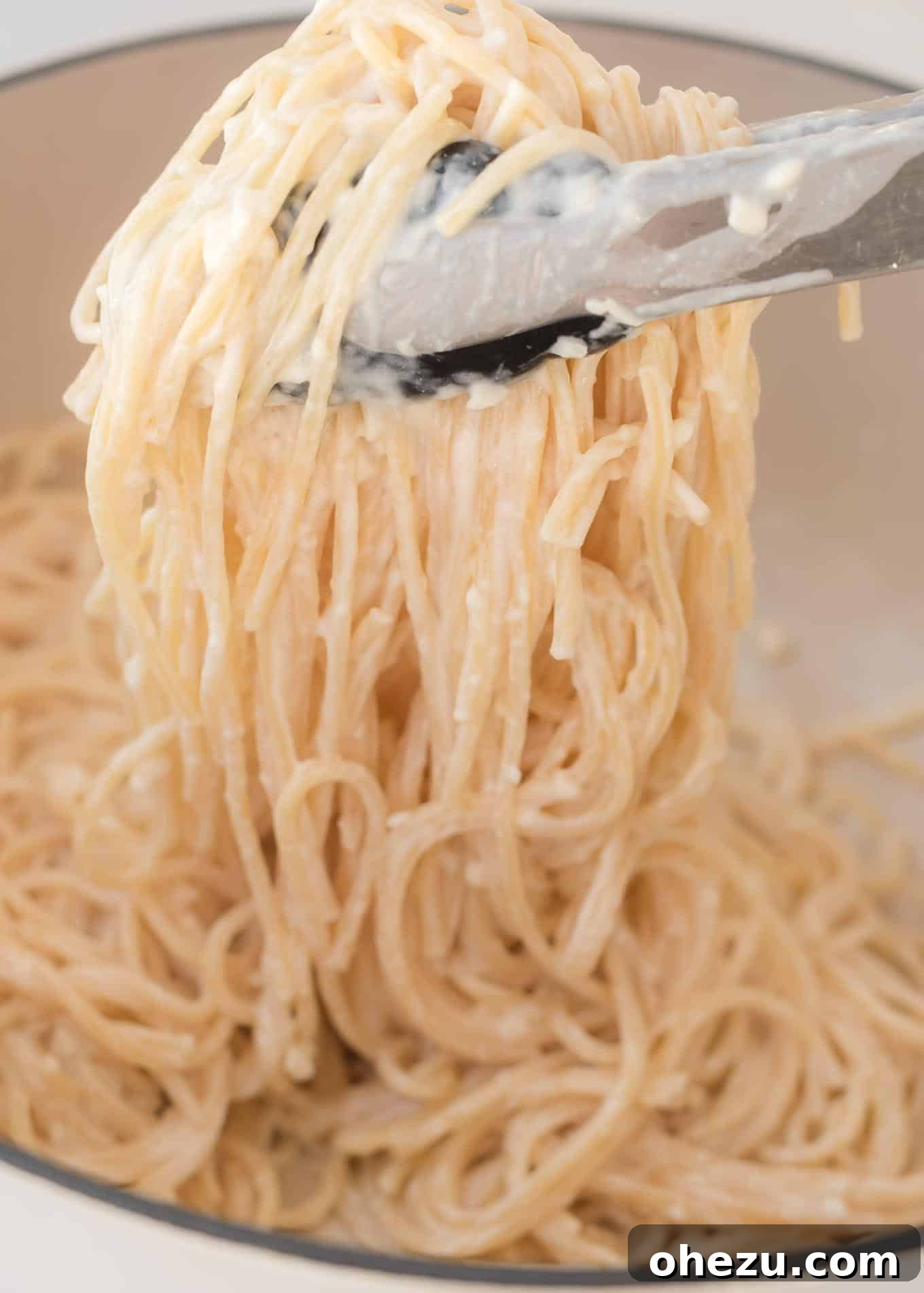 A close-up of creamy cream cheese pasta with fresh herbs, ready to be eaten