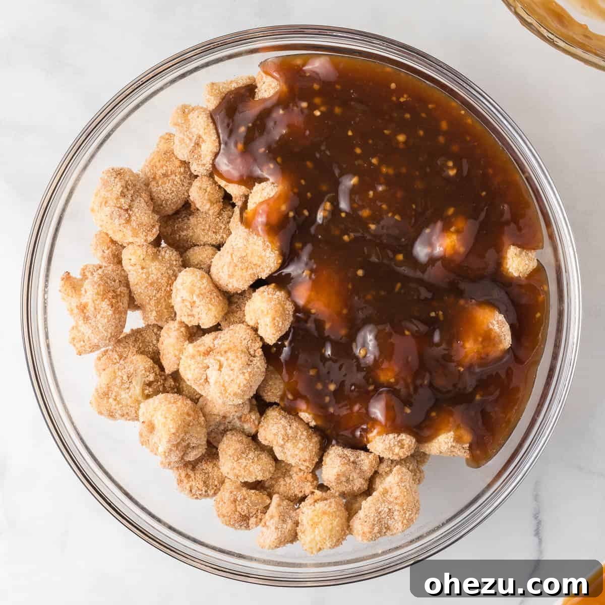 adding the teriyaki sauce to the cauliflower
