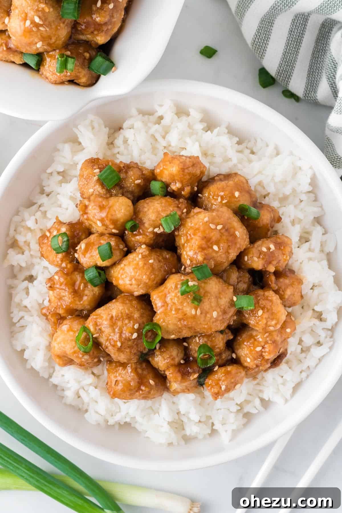 teriyaki cauliflower over rice in a white bowl