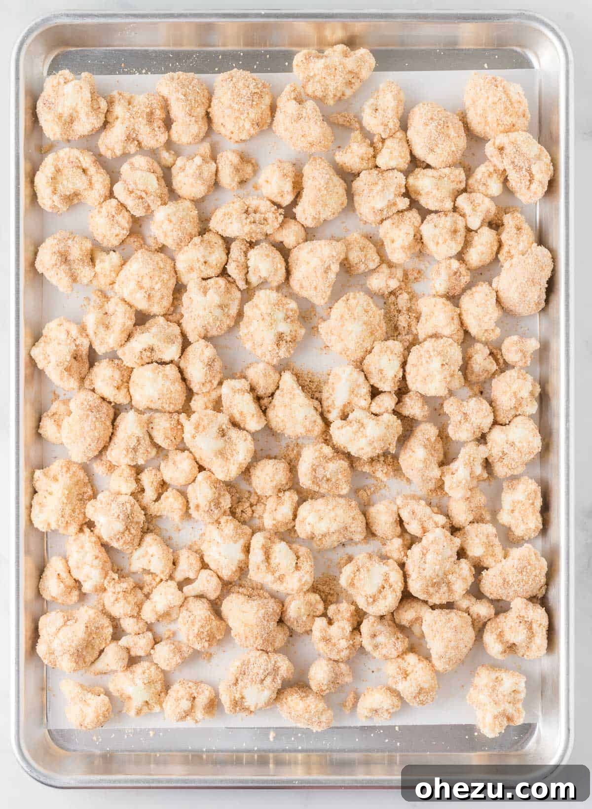 breaded cauliflower on a baking sheet