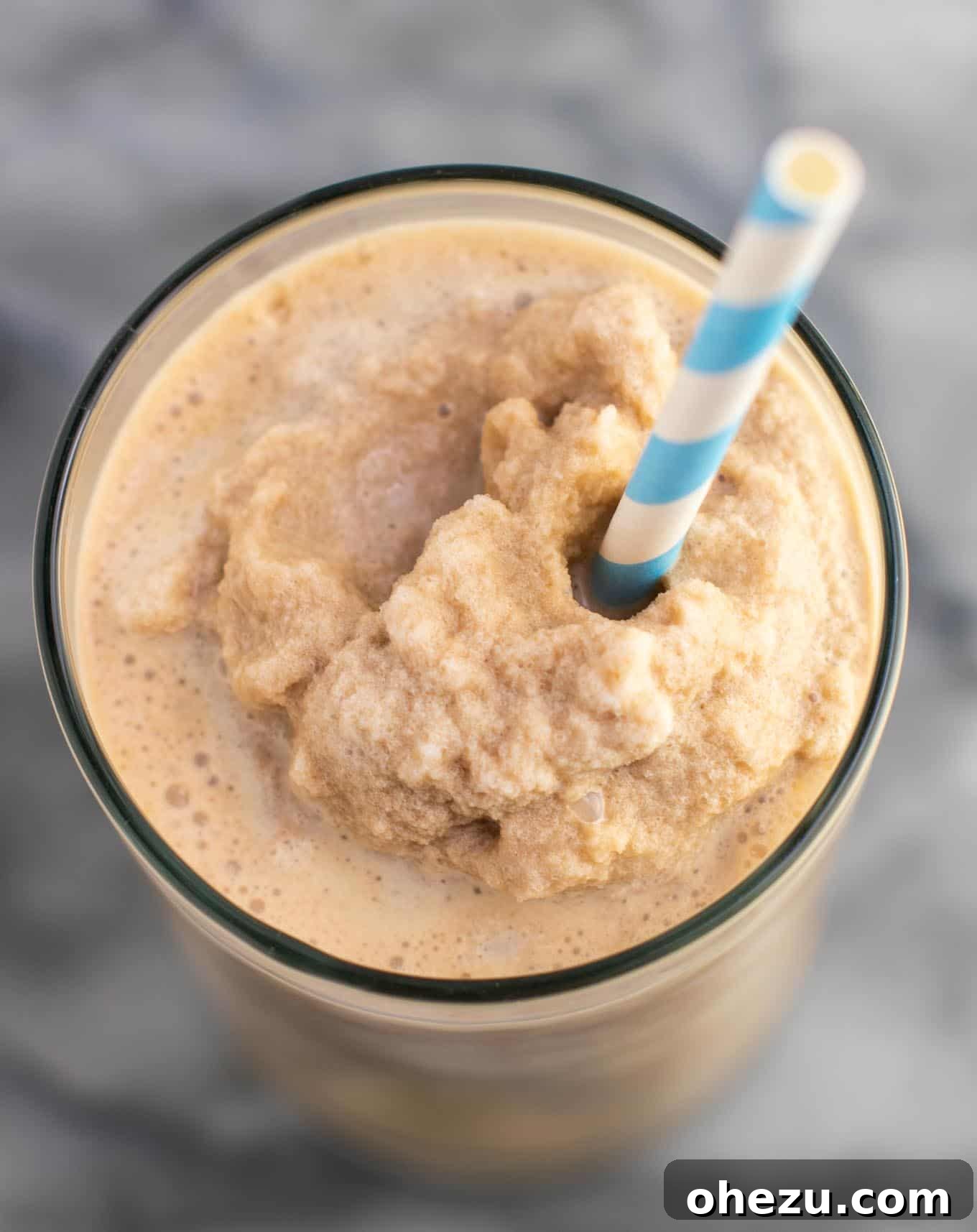 Delicious frozen coffee in a glass with a straw, ready to drink