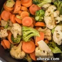 Crispy air-fried frozen mixed vegetables in an air fryer basket