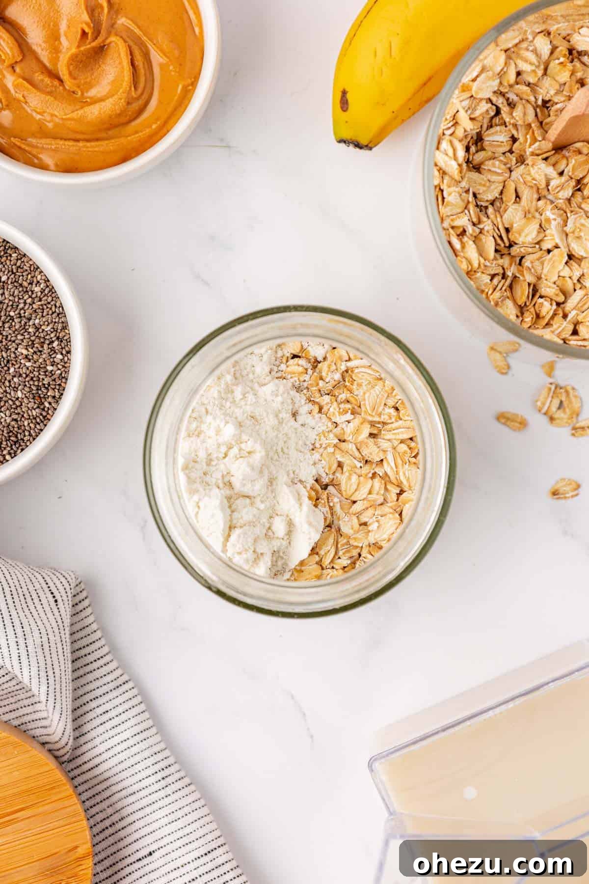 adding protein powder and oats to the jar