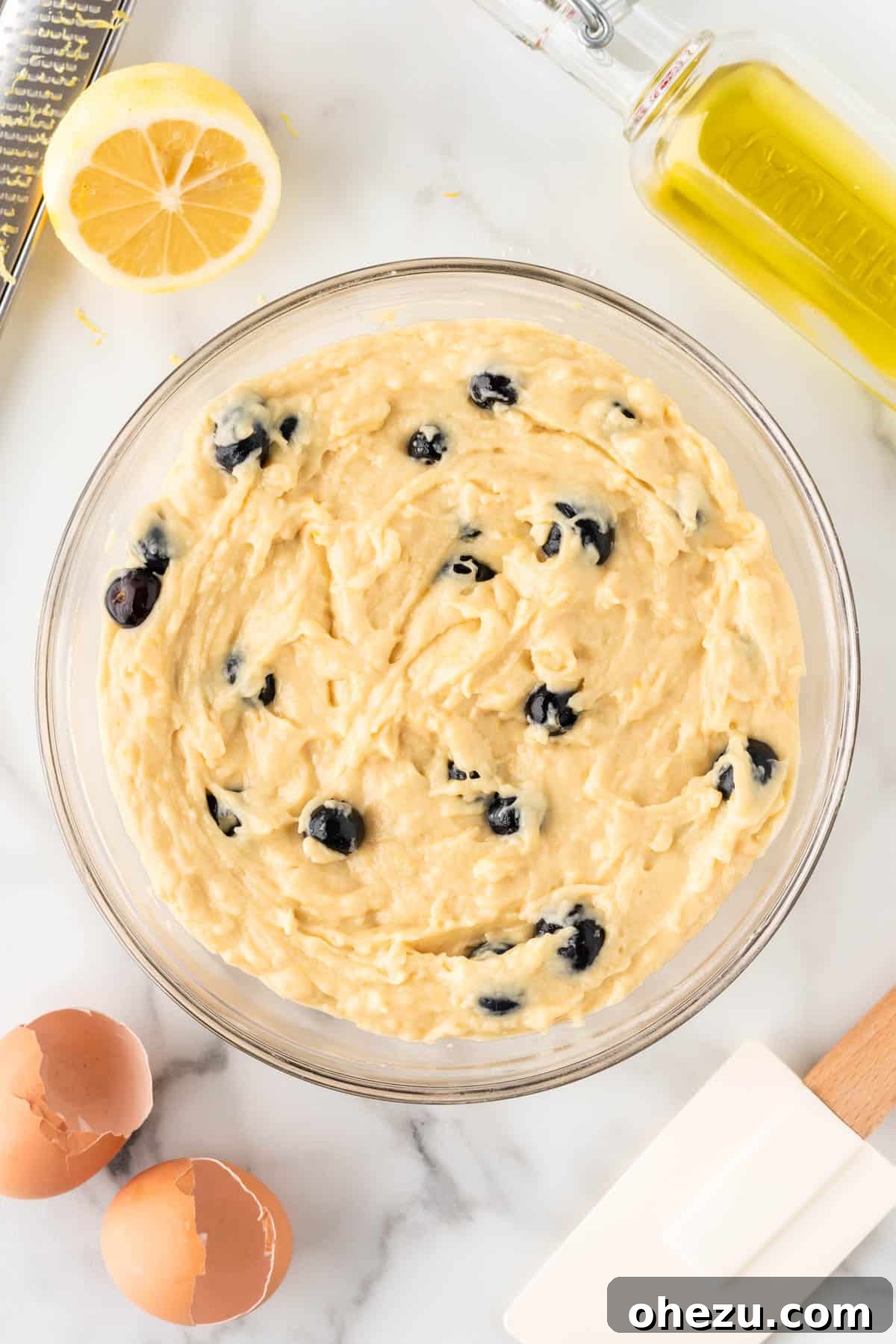 Moist Greek Yogurt Blueberry Muffins 11 Blueberry muffin batter with blueberries evenly distributed, resting in a bowl, ready for scooping into muffin tins.