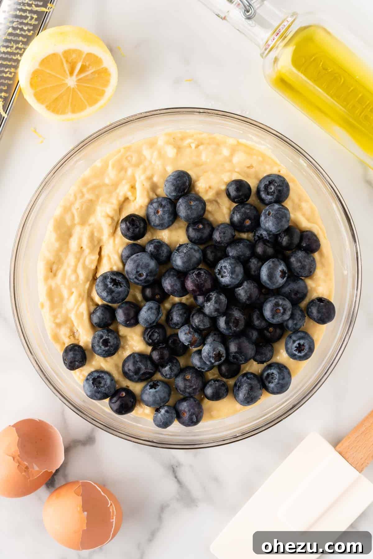 Moist Greek Yogurt Blueberry Muffins 10 Gently folding fresh, plump blueberries into the mixed muffin batter using a rubber spatula to avoid crushing them.
