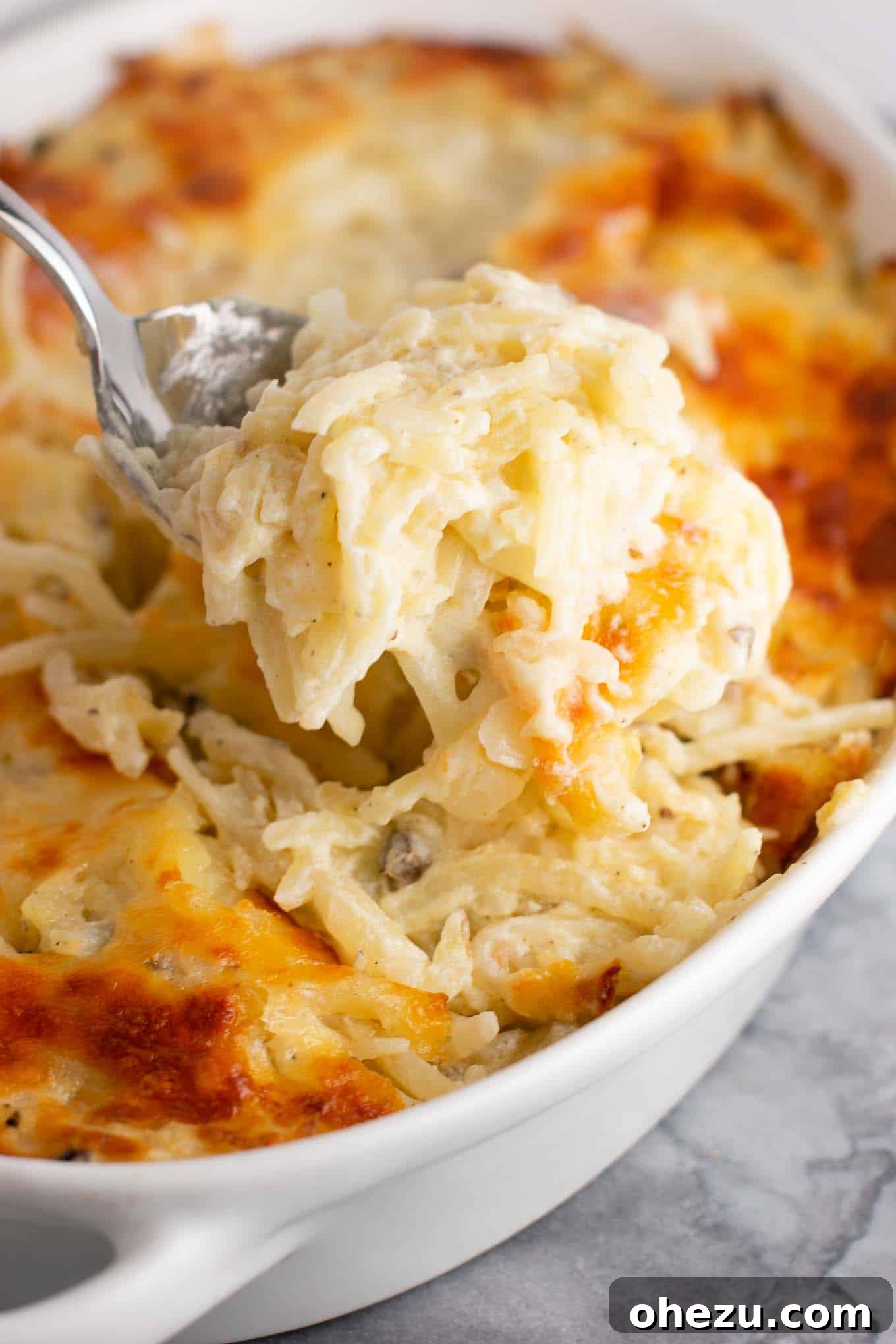 A generous serving of golden-brown vegetarian hash brown casserole, inviting for a comforting breakfast or brunch