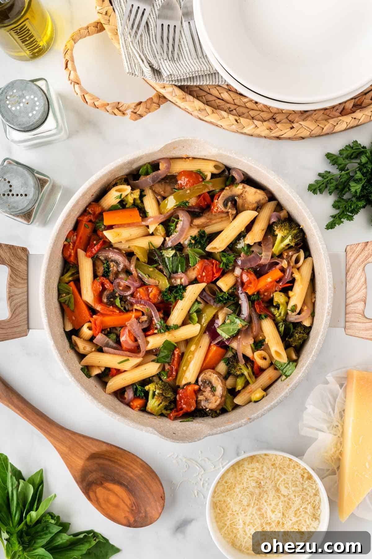 The finished roasted vegetable pasta, perfectly mixed with herbs, resting in a large saucepan.