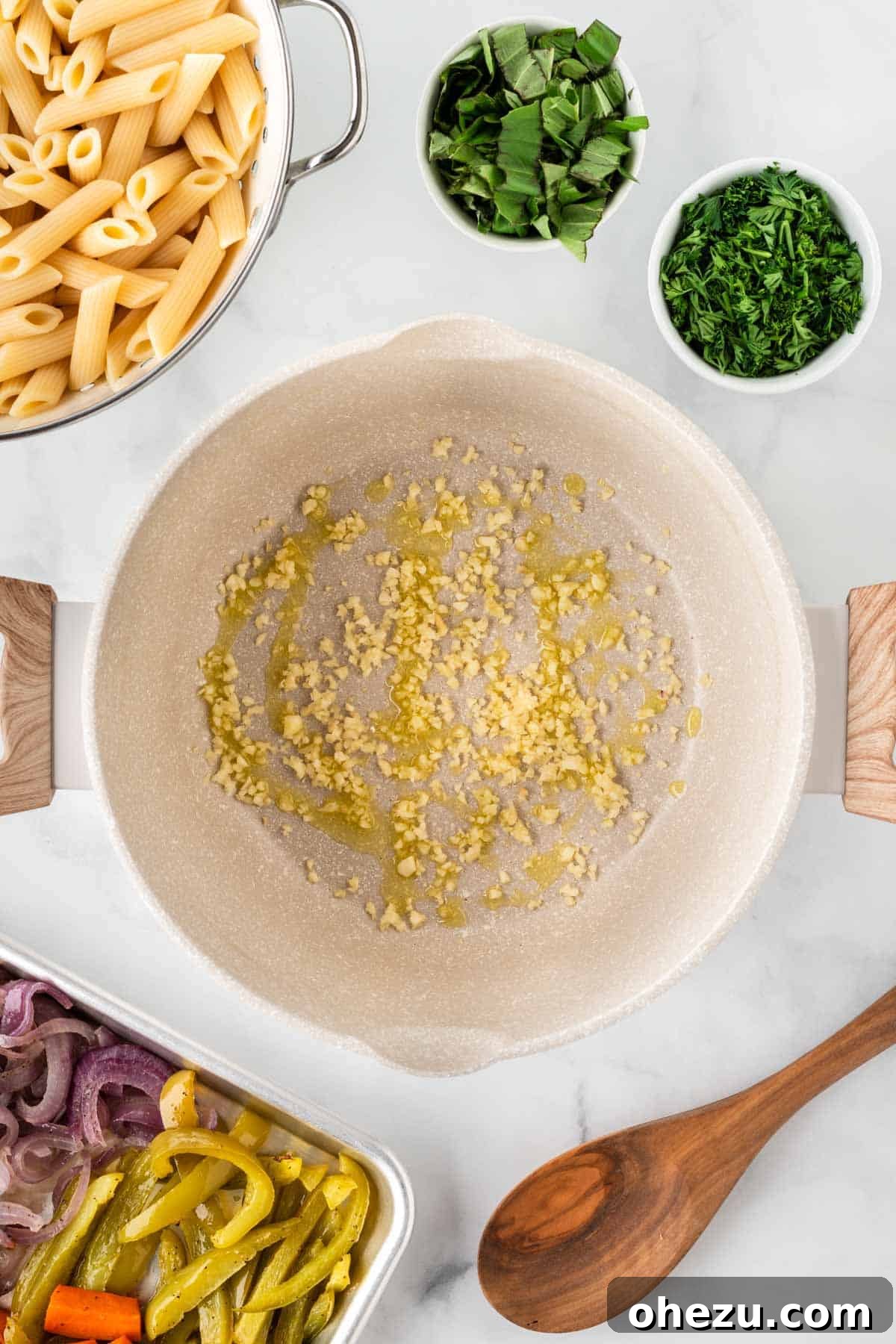Minced garlic gently sizzling in a small amount of olive oil in a saucepan, infusing the oil with its aroma.